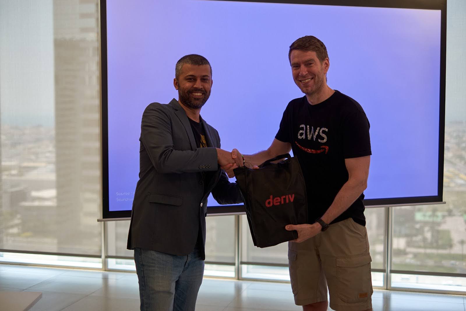 AWS Community Head receiving a Deriv welcome kit